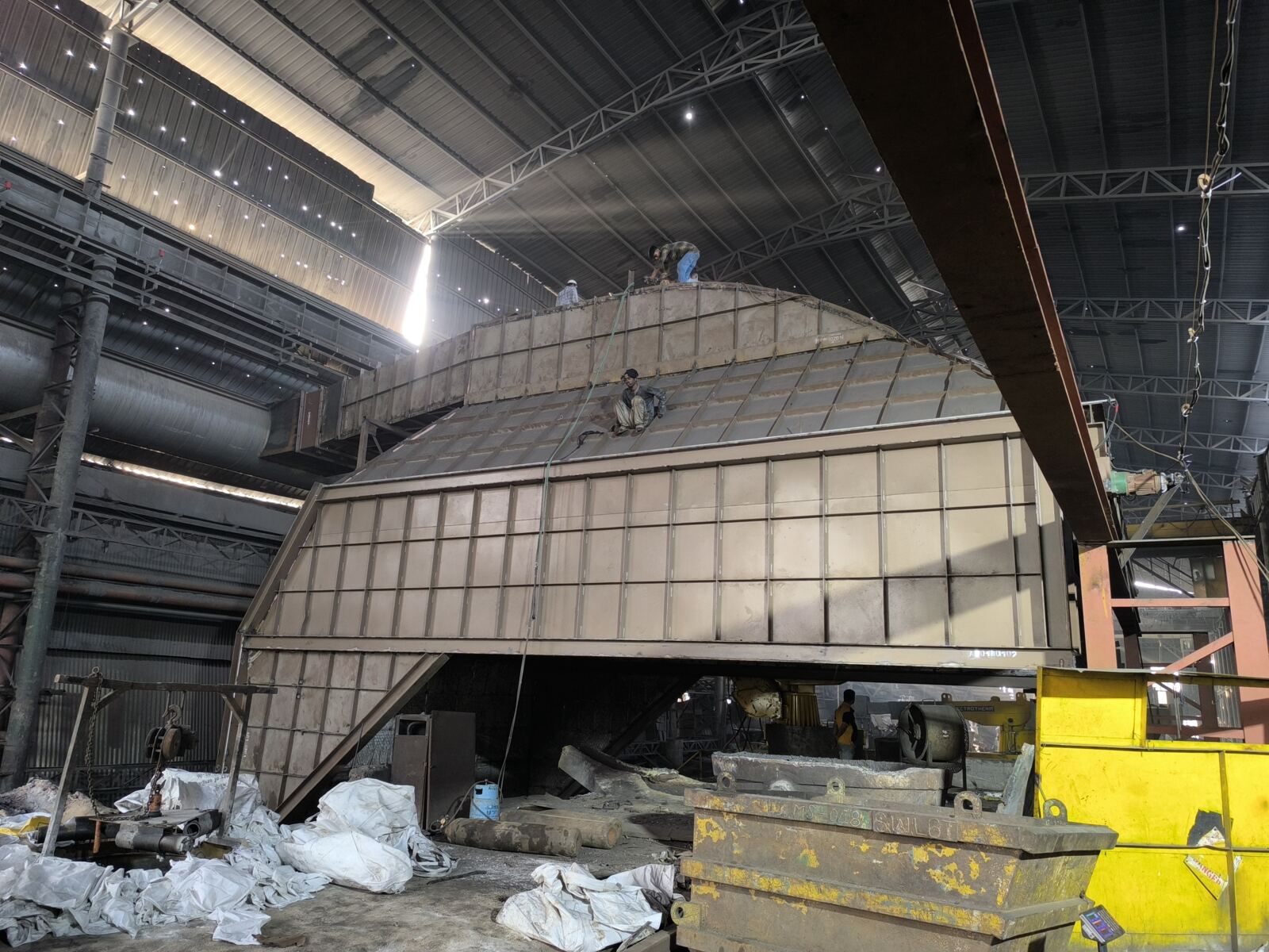 Fully enclosed dog house over the induction furnace