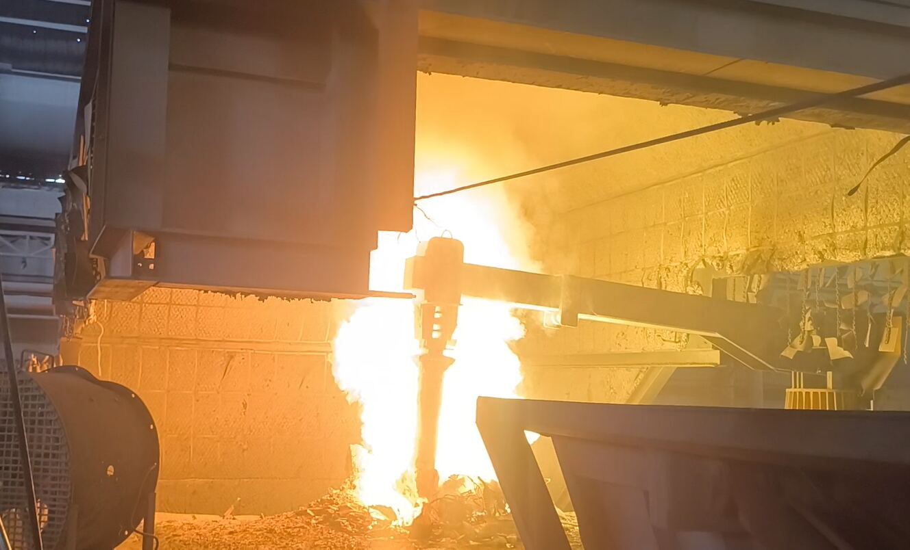 Scrap picking arm working at the furnace mouth